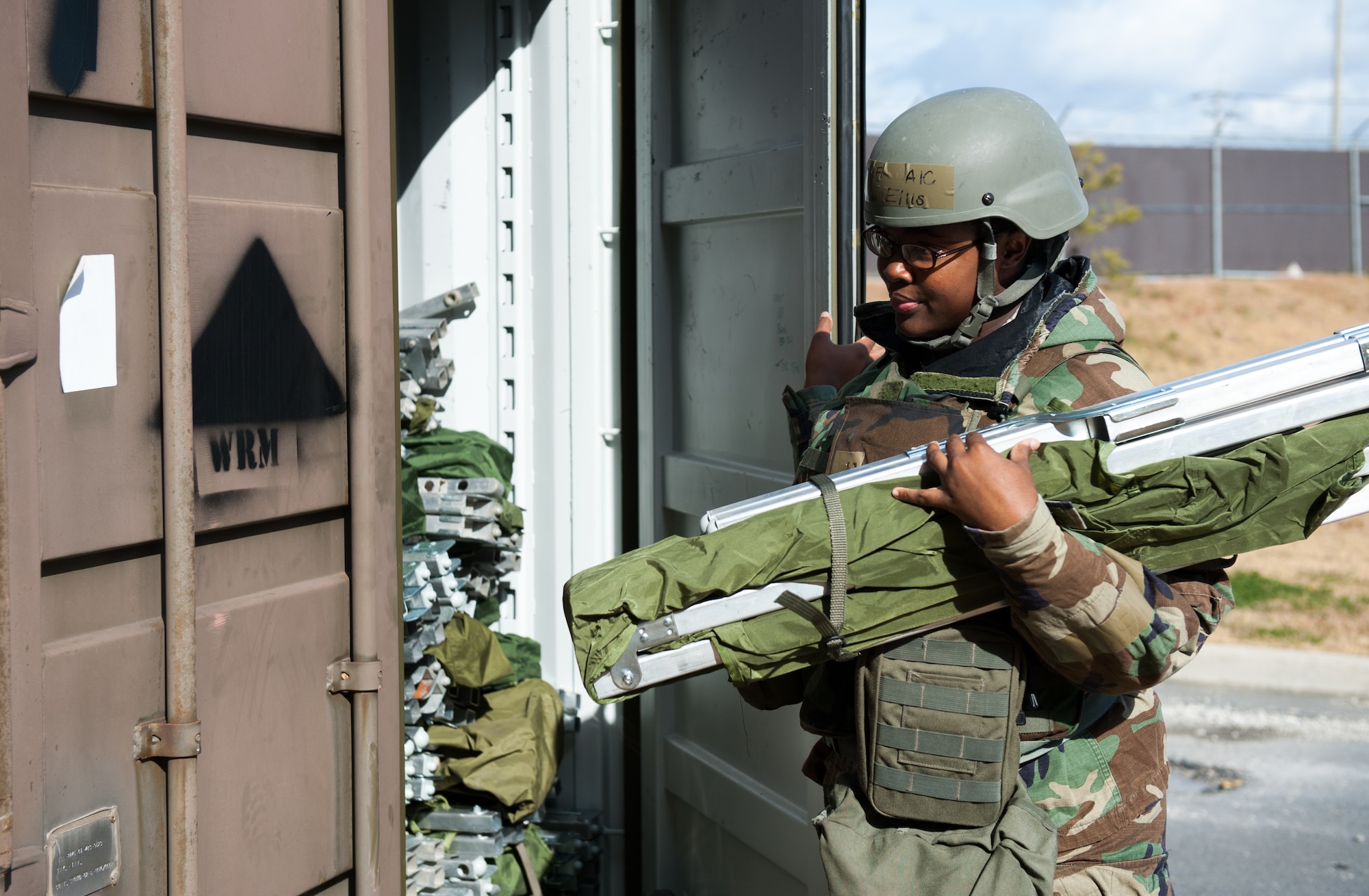 Airman 1st Class Ashley Ellis, 8th Force Support Squadron, retrieves a cot for a new resident of the chemical-protected dorm during exercise Beverly Bulldog 14-1 at Kunsan Air Base, Republic of Korea, Nov. 18, 2013. The 8th Fighter Wing demonstrates its ability to room multiple Airmen in its chemical protection system dormitories. Airmen were moved from their non-protected dorms into shared rooms in CPS dormitories. The exercise tested the wartime mission alongside other 7th Air Force units and supporting organizations with an emphasis on the operational and tactical levels of war during the peninsula-wide exercise. (U.S. Air Force photo by Senior Airman Armando A. Schwier-Morales/Released)