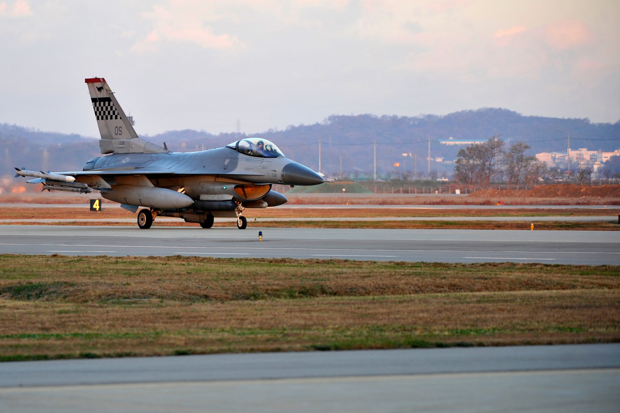 An F-16 Fighting Falcon from the 36th Fighter Squadron taxis down the flight line before taking off during the first sortie of Operational Readiness Exercise Beverly Bulldog 14-01 at Osan Air Base, Republic of Korea, Nov. 18, 2013. The wing executes military operations to beddown, maintain and employ follow-on forces for the combined arms base that includes three major flying tenants and large multiservice fighting units. (U.S. Air Force photo/Staff Sgt. Emerson Nuñez)