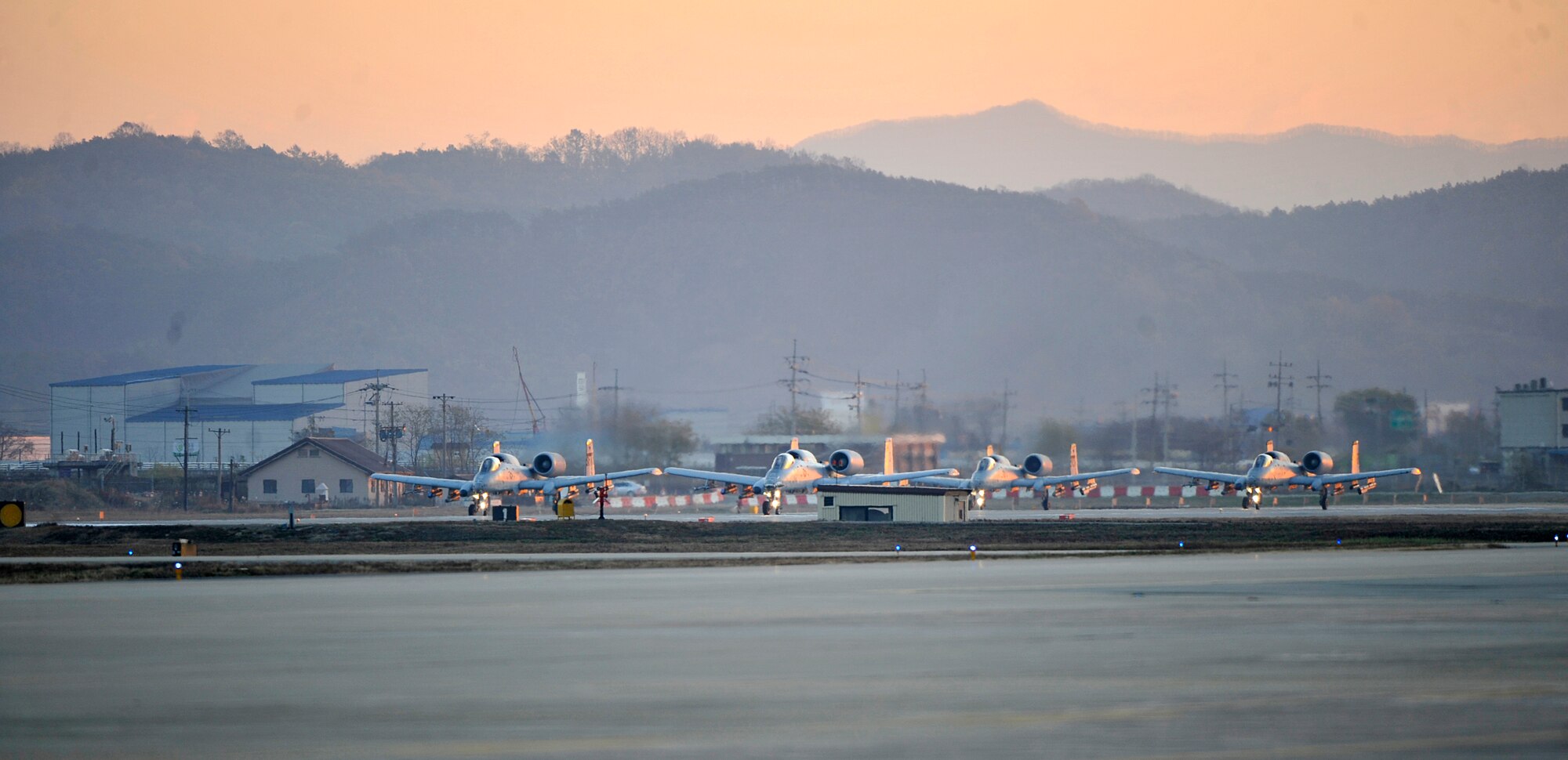 Four A-10 Thunderbolts from the 25th Fighter Squadron prepare to take off during the first sortie of Operational Readiness Exercise Beverly Bulldog 14-01 at Osan Air Base, Republic of Korea, Nov. 18, 2013. The week-long exercise tests Airmen’s abilities during a heightened state of readiness while providing combat ready forces for close air support, air strike control, forward air control-airborne, combat search and rescue, counter air and fire, and interdiction in the defense of the ROK. (U.S. Air Force photo/Staff Sgt. Emerson Nuñez)