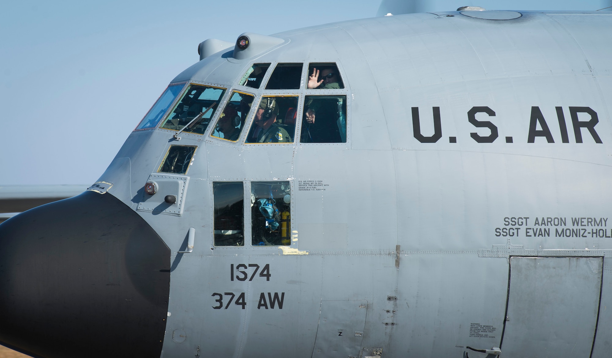 A crew chief with the 374th Aircraft Maintenance Squadron talks with a pilot in a C-130 Hercules leaving for the Republic of the Philippines in support of Operation Damayan at Yokota Air Base, Japan, Nov. 16, 2013. The 36th Airlift Squadron deployed to assist the relief efforts after Super Typhoon Haiyan/Yolanda devastated the country. (U.S. Air Force photo by Staff Sgt. Chad C. Strohmeyer/Released)