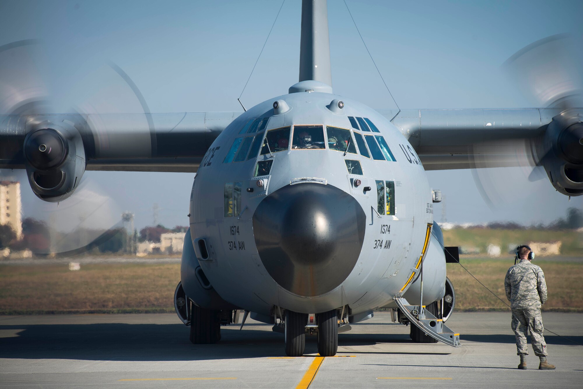 A crew chief with the 374th Aircraft Maintenance Squadron talks with a pilot in a C-130 Hercules leaving for the Republic of the Philippines in support of Operation Damayan at Yokota Air Base, Japan, Nov. 16, 2013. The 36th Airlift Squadron deployed to assist the relief efforts after Super Typhoon Haiyan/Yolanda devastated the country. (U.S. Air Force photo by Staff Sgt. Chad C. Strohmeyer/Released)