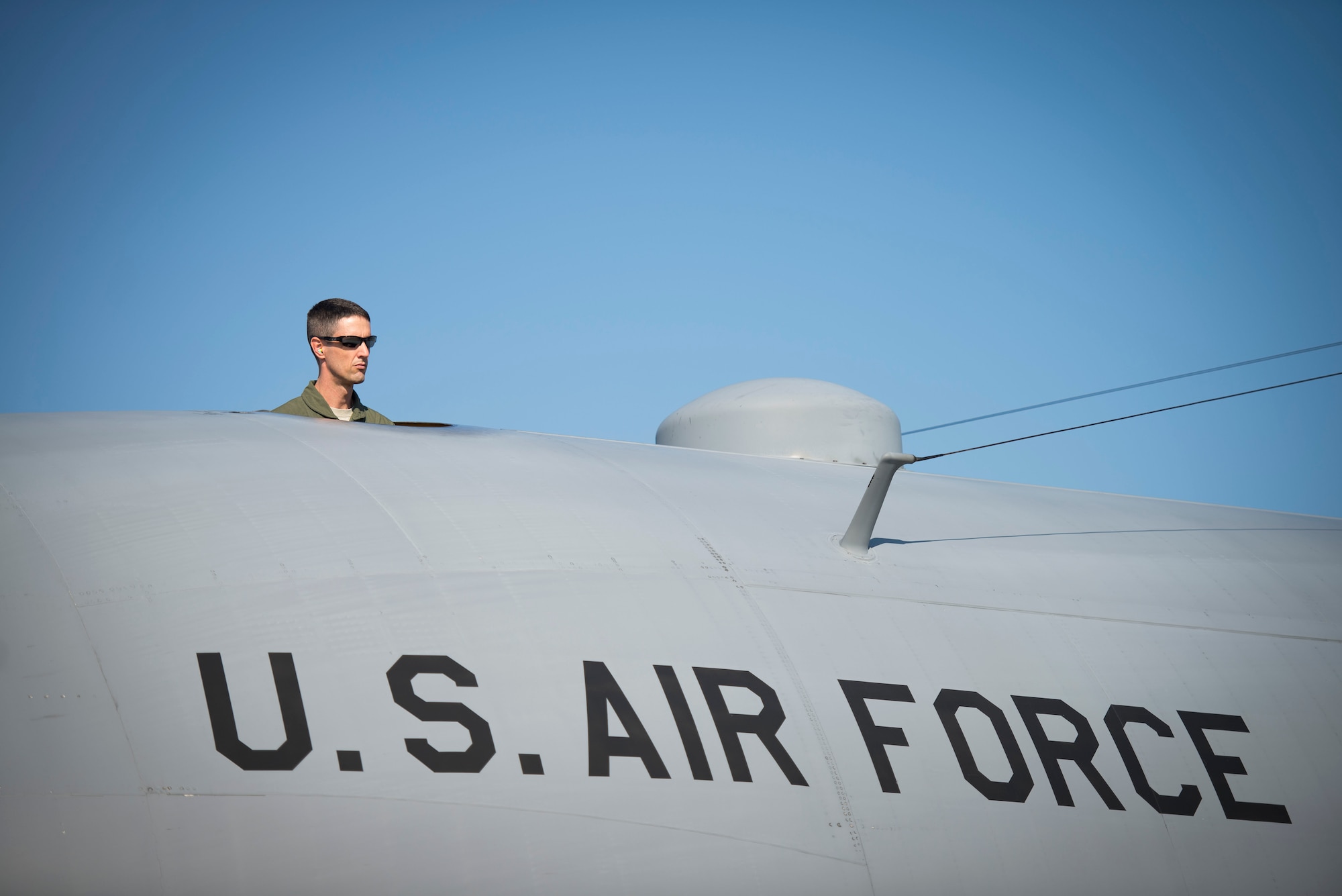 Lt. Col. Jeff Kingsley, 5th Air Force chief of safety, surveys the flightline on top of a C-130 Hercules prior to leaving for the Republic of the Philippines in support of Operation Damayan at Yokota Air Base, Japan, Nov. 16, 2013. The 36th Airlift Squadron deployed to assist the relief efforts after Super Typhoon Haiyan/Yolanda devastated the country. (U.S. Air Force photo by Staff Sgt. Chad C. Strohmeyer/Released)