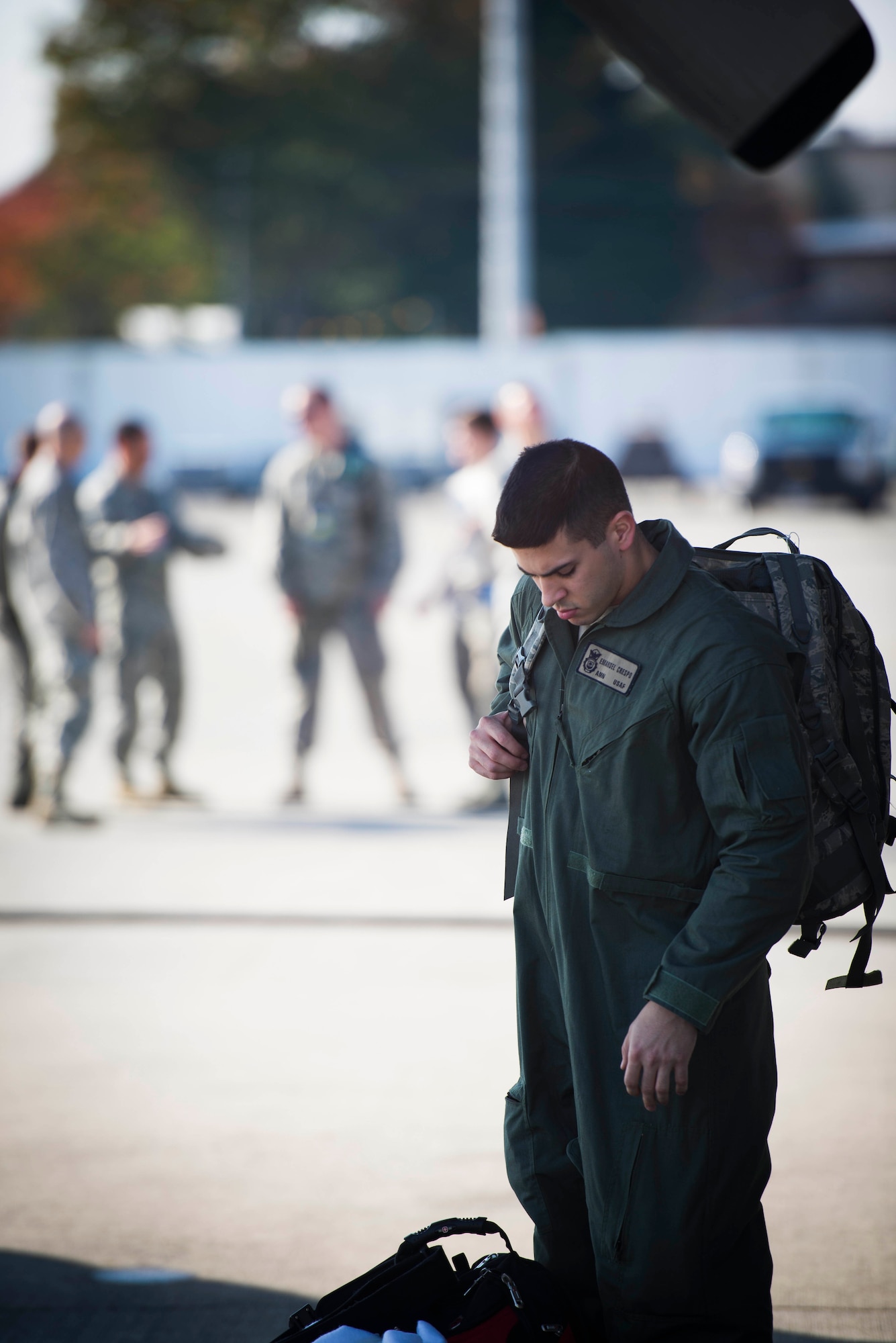 Airman 1st Class Emanuel Crespo, 374th Security Forces Squadron patrolmen, reaches for his bag to load it on a C-130 Hercules leaving for the Republic of the Philippines in support of Operation Damayan at Yokota Air Base, Japan, Nov. 16, 2013. The 36th Airlift Squadron deployed to assist the relief efforts after Super Typhoon Haiyan/Yolanda devastated the country. (U.S. Air Force photo by Staff Sgt. Chad C. Strohmeyer/Released)