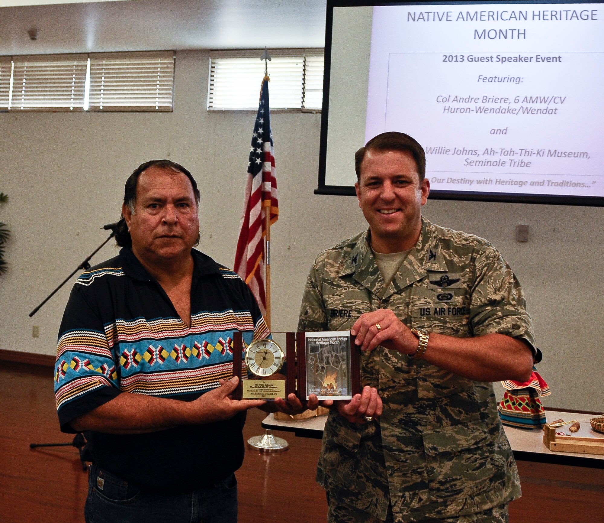 Col. Andre Briere, 6th Air Mobility Wing vice commander, presents a token of appreciation to Willie Johns, guest speaker and member of the Seminole Tribe, during a National American Indian Heritage Month lunch and learn Nov. 13, 2013, at MacDill Air Force Base, Fla. (U.S. Air Force photo by Senior Airman Michael Ellis/Released)   
