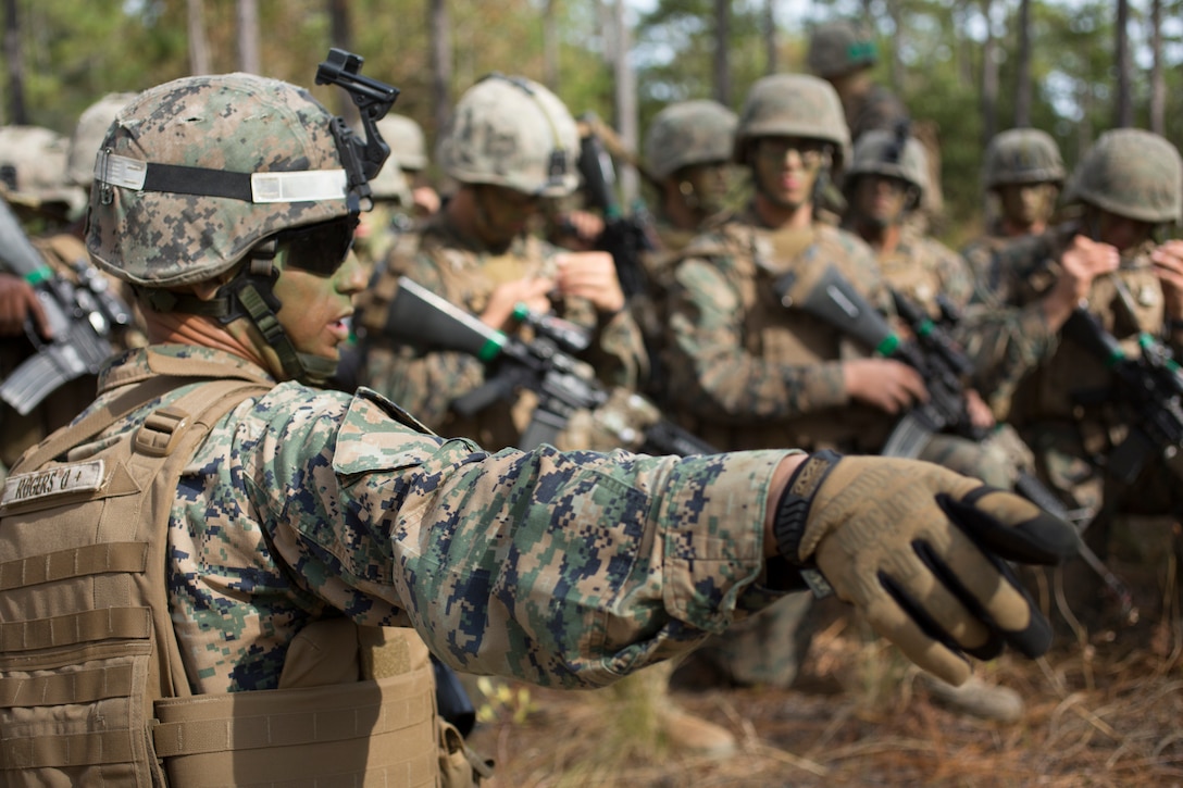 Marine Sergeant David Rogers from Delta Company, Infantry Training Battalion, School of Infantry East passes final instructions before assaulting an objective during the Infantry Integrated Field Training Exercise on Camp Geiger, N.C., Nov. 15, 2013. 