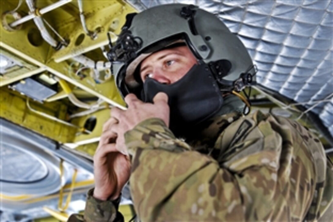 U.S. Army Sgt. Kelly Fisher fastens his face shield before conducting a mission to move personnel and cargo on Bagram Airfield, Afghanistan, Nov. 9, 2013. Fisher, a member of the Oklahoma National Guard, is assigned to 3rd Battalion, 10th Combat Aviation Brigade. 