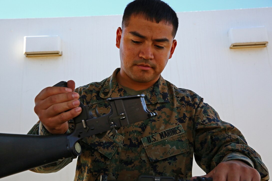 Corporal Dehorta, asmall arms repair technician, Combat Logistics Battalion 15, Combat Logistics Regiment 17, 1st Marine Logistics Group, takes apart a weapon to ensure that each piece functions properly aboard Camp Pendleton, Calif., Nov. 13, 2013. As a lance corporal, he was the Marine of the Quarter and the Marine of the year. Now he is the Noncommissioned Officer of the Quarter.
