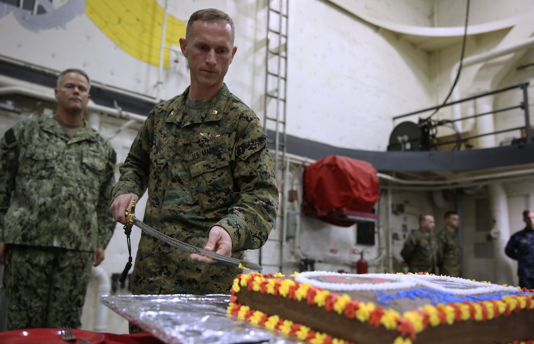 Major David Hill, the officer in charge of the Marines onboard the USS New York, cuts the first piece of birthday cake for the Marine Corps’ 238th birthday aboard the USS New York Nov. 7, 2013. The Marines and sailors celebrated the birthday with cake and music while underway to New York City for Veteran’s Day weekend.
