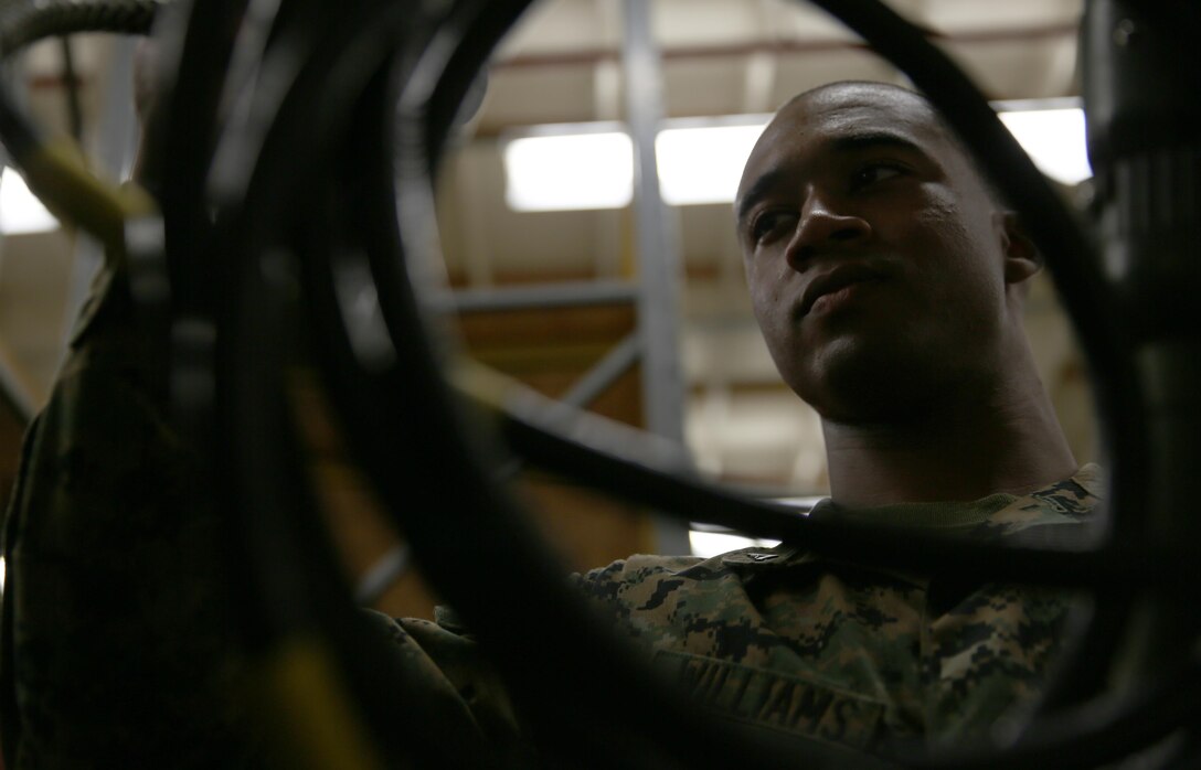 Lance Cpl. Ryan Williams, a field wireman with Marine Wing Communications Squadron 38, Detachment A and a New Orleans checks a length of wiring for cracks or damage aboard Marine Corps Air Station Miramar, Calif., Nov. 14. Field wiremen ensure that messages get to where they are needed quickly and securely.


