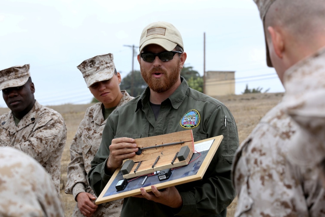 Jonathon Taylor, counter improvised explosive device instructor, shows Marines and sailors a type of IED and its different components during the counter IED class given as part of the Predeployment Training Program.  The counter IED instructors taught inside the classroom for a portion of their class and then took the Marines and sailors outside to show them certain indicators and where to look for IEDs while in Afghanistan.