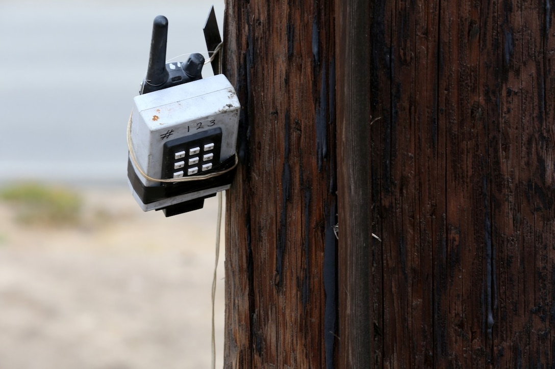 A receiver for a simulated remote controlled improvised explosive device is attahced to a telephone pole showing Marines and sailors in the Predeployment Training Program that IEDs are not just on the ground.  Counter IED instructors taught inside the classroom for a portion of their class and then took the Marines and sailors outside to show them an overview of different types of IEDs and their indicators.