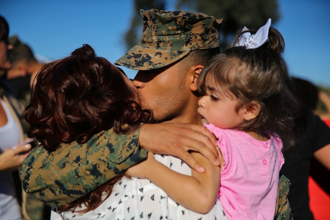 A Marine with Bravo Company, 3rd Assault Amphibian Battalion, greets his family with hugs and kisses during the company’s homecoming here, Nov. 14, 2013. The Marines returned after a six-month deployment to Okinawa, Japan. During the deployment, the company conducted training with foreign militaries and completed platoon and company exercises at the Combine Arms Training Center Camp Fuji.