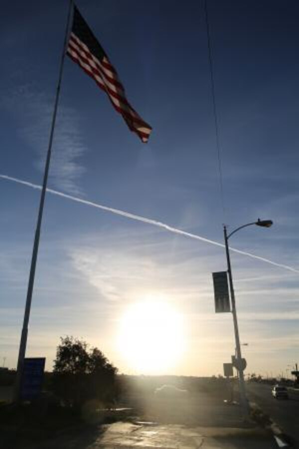 A military banner posted behind an American flag on Main Street in Barstow, Calif., Nov. 18. With a strong military presence in the community, Barstow honors active duty residents by posting their names and branch of service throughout the town.


