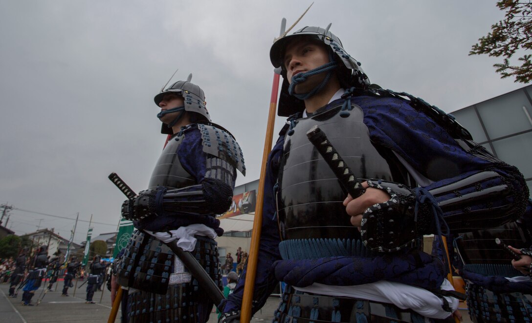 Sgt. Justin Pack, operations chief with the station Public Affairs Office, and Cpl. Javier King personnel administrator with station installation personnel administration center, march around a plaza during the Kuragake Castle Festival, Nov. 17 2013. Pack and King were two of five Marines from Marine Corps Air Station Iwakuni, Japan, to participate in this event, which celebrated a battle that occurred during the 16th century in Kuga, Iwakuni City. 