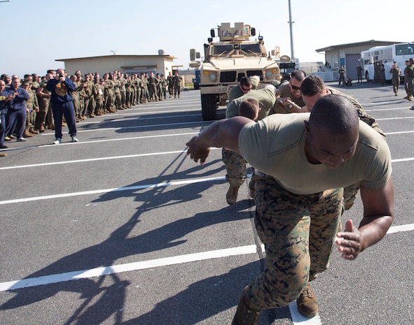 Participants in the Marine Aircraft Group 12 field meet pull a mine resistant ambush protected vehicle while at Penny Lake Fields, Nov. 8, 2013. The field meet consisted of more than 15 different events, most notably the MRAP vehicle pull.