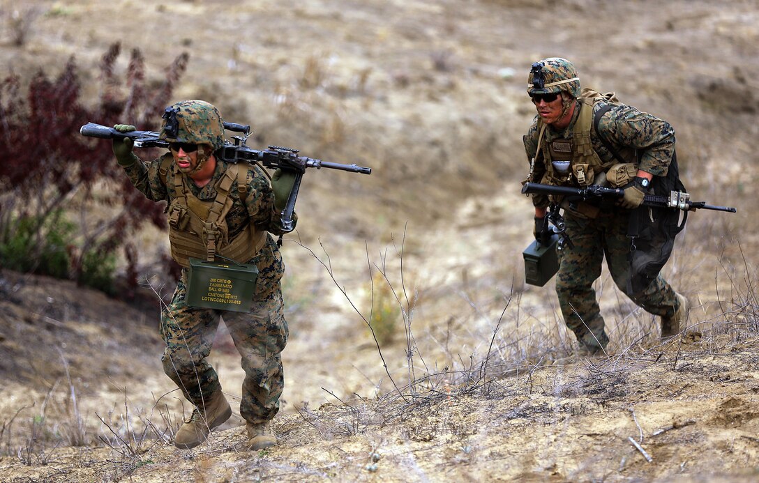 Pfc. Colton Welker and Lance Cpl. Cody Grunwald hike up a hill towards their position to suppress the enemy during Range 706 for the Advanced Infantryman Course on Nov. 19. Range 706 is a combined arms range that includes mortars, machine guns, demolitions, breach clearing, and fire and movement. The Advanced Infantryman Course provides infantry qualified Marines with the training necessary to become a successful infantry squad leader, the course teaches each infantryman proper patrolling techniques, urban combat tactics, defensive tactics and offensive tactics as a squad leader. 