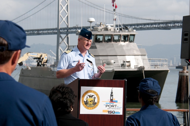Coast Guard Capt. Thomas Crabbs, Pacific Area chief of operations, speaks to guests attending the Port of San Francisco’s Defense Support of Civilian Authorities Tabletop Exercise at Pier 1 in San Francisco, Nov. 18. The San Francisco District’s command vessel the M/V John A. B. Dillard, Jr., can be seen in the background assisting in the exercise. 