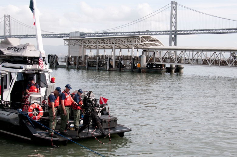 A Coast Guard Diver enters the water during a simulated disaster response at Pier 1 in San Francisco, Nov. 18.