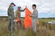 OHAKEA, New Zealand -- United States Air Force Maj. Corey Akiyama (right) explains the alignment of a target panel, or marker, to Royal New Zealand Air Force Pilot Officer Emma Taylor during Exercise Kiwi Flag Nov. 14 at the New Zealand Defence Force Raumi Drop Zone near Ohakea, New Zealand.  Kiwi Flag personnel are supporting Exercise Southern Katipo -- held on New Zealand’s South Island -- by managing air operations and providing cargo and passenger airlift including tactical air drops to SK participants. SK hosts nine countries involved in air, land and maritime operations. (U.S. Air Force photo by Senior Master Sgt. Denise Johnson)