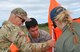 OHAKEA, New Zealand -- (Left to right) United States Air Force Chief Master Sgt. Paul Koester and Maj. Corey Akiyama demonstrate how to set up a heavy equipment point-of-impact marker for Royal New Zealand Air Force Pilot Officer Emma Taylor as the team prepare an aerial-cargo drop zone during Exercise Kiwi Flag Nov. 14 at the New Zealand Defence Force Raumi Drop Zone near Ohakea, New Zealand.  Kiwi Flag personnel are supporting Exercise Southern Katipo -- held on New Zealand’s South Island -- by managing air operations and providing cargo and passenger airlift including tactical air drops to SK participants. SK hosts nine countries involved in air, land and maritime operations. (U.S. Air Force photo by Senior Master Sgt. Denise Johnson/Released)