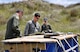 OHAKEA, New Zealand -- (Left to right) United States Air Force Staff Sgt. Robert Gallagher and Maj. Corey Akiyama demonstrate U.S. Air Force protocols for checking the integrity of dropped cargo for Royal New Zealand Air Force Pilot Officer Emma Taylor (right) as she earns her U.S. Air Force drop zone safety officer certification during Exercise Kiwi Flag Nov. 14 at the New Zealand Defence Force Raumi Drop Zone near Ohakea, New Zealand. Kiwi Flag personnel are supporting Exercise Southern Katipo -- held on New Zealand’s South Island -- by managing air operations and providing cargo and passenger airlift including tactical air drops to SK participants. SK hosts nine countries involved in air, land and maritime operations. (U.S. Air Force photo by Senior Master Sgt. Denise Johnson)