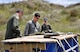 OHAKEA, New Zealand -- (Left to right) United States Air Force Staff Sgt. Robert Gallagher and Maj. Corey Akiyama demonstrate U.S. Air Force protocols for checking the integrity of dropped cargo for Royal New Zealand Air Force Pilot Officer Emma Taylor (right) as she earns her U.S. Air Force drop zone safety officer certification during Exercise Kiwi Flag Nov. 14 at the New Zealand Defence Force Raumi Drop Zone near Ohakea, New Zealand. Kiwi Flag personnel are supporting Exercise Southern Katipo -- held on New Zealand’s South Island -- by managing air operations and providing cargo and passenger airlift including tactical air drops to SK participants. SK hosts nine countries involved in air, land and maritime operations. (U.S. Air Force photo by Senior Master Sgt. Denise Johnson)