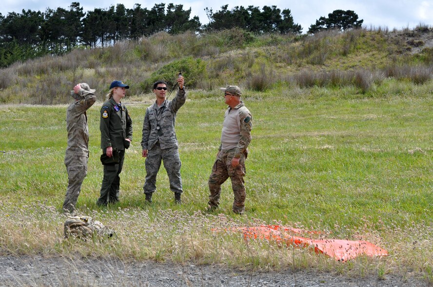 OHAKEA, New Zealand -- United States Air Force Maj. Corey Akiyama checks wind velocity as (left to right) New Zealand Army Private Hamish Summers, Royal New Zealand Air Force Pilot Officer Emma Taylor and United States Air Force Chief Master Sgt. Paul Koester await the reading as the team prepare an aerial-cargo drop zone during Exercise Kiwi Flag Nov. 14 at the New Zealand Defence Force Raumi Drop Zone near Ohakea, New Zealand. The wind checks are a task which must be repeated regularly prior to the drop to ensure conditions don’t exceed safety requirements for the crew and equipment. Taylor is earning her certification as a United States Air Force drop zone safety officer during the multilateral RNZAF-sponsored tactical airlift exercise comprising air assets from the USAF, RNZAF, Royal Australian Air Force, Republic Of Singapore Armed Forces and French Armed Forces of New Caledonia. Taylor’s certification will enhance interoperability and unified responses when New Zealand and the United States both respond to a combined effort. Summers is from 51st Aerial Delivery Platoon, 5th Movements Company, 2nd Combat Services Support Battalion out of Linton Military Camp in Palmerston North, New Zealand. Taylor, an air warfare officer, is assigned to 40 Squadron, RNZAF Base Ohakea. Akiyama is deployed as the 517th Expeditionary Airlift Squadron drop zone safety officer. He is the air mobility liaison officer for the 615th Contingency Operations Support Group at home station, Camp Henry, Korea. He hails from University Place, Wash. Koester is deployed as the 517th EAS jumpmaster. He is the pararescue functional manager at home station, Pacific Air Forces Headquarters at Joint Base Pearl Harbor-Hickam, Hawaii. He hails from Colorado Springs, Colo. Kiwi Flag personnel are supporting Exercise Southern Katipo -- held on New Zealand’s South Island -- by managing air operations and providing cargo and passenger airlift including tactical air drops to SK participants. SK hosts nine