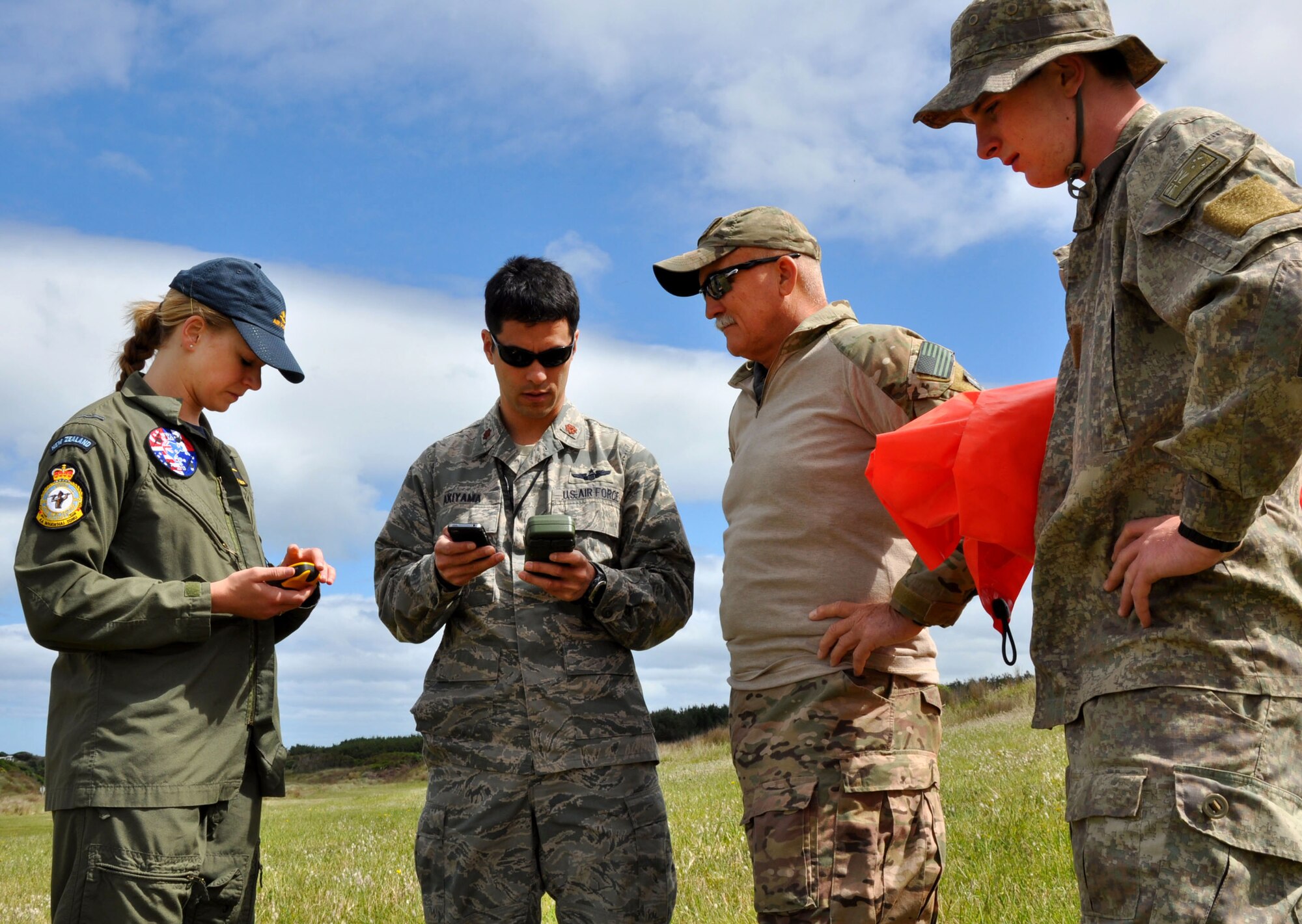 OHAKEA, New Zealand -- (Left to right) Royal New Zealand Air Force Pilot Officer Emma Taylor checks wind velocity and direction with an anemometer (wind meter) and a compass as part of the requirements to earn her United States drop zone safety officer certification during Exercise Kiwi Flag Nov. 14 at the New Zealand Defence Force Raumi Drop Zone near Ohakea, New Zealand. Kiwi Flag personnel are supporting Exercise Southern Katipo -- held on New Zealand’s South Island -- by managing air operations and providing cargo and passenger airlift including tactical air drops to SK participants. SK hosts nine countries involved in air, land and maritime operations. (U.S. Air Force photo by Senior Master Sgt. Denise Johnson)