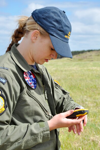 OHAKEA, New Zealand -- Royal New Zealand Air Force Pilot Officer Emma Taylor checks wind velocity and direction with an anemometer (wind meter) and a compass as part of the requirements to earn her United States drop zone safety officer certification Nov. 14 at the New Zealand Defence Force Raumi Drop Zone near Ohakea, New Zealand. Taylor is earning the certification during the multilateral RNZAF-sponsored tactical airlift exercise, Kiwi Flag, comprising air assets from the USAF, RNZAF, Royal Australian Air Force, Republic Of Singapore Armed Forces and French Armed Forces of New Caledonia. Taylor, an air warfare officer, is assigned to 40 Squadron, RNZAF Base Ohakea. Kiwi Flag personnel are supporting Exercise Southern Katipo -- held on New Zealand’s South Island -- by managing air operations and providing cargo and passenger airlift including tactical air drops to SK participants. SK hosts nine countries involved in air, land and maritime operations. (U.S. Air Force photo by Senior Master Sgt. Denise Johnson/Released)