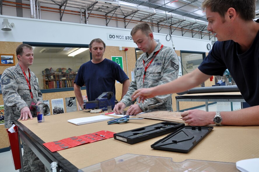 (Left to right) U.S. Air Force Master Sgt. Adam Keele, Royal New Zealand Air Force Gene Angus, U.S. Air Force Staff Sgt. Tyrell Pennington and RNZAF Karl Waiaraki discuss a newly-crafted auxiliary power unit inlet door target sensor at the RNZAF Base Ohakea’s Maintenance Support Squadron Structural Repair Bay Nov. 13 in Ohakea, New Zealand. Keele, 517th Expeditionary Airlift Squadron production superintendent, enlisted the aid of RNZAF structural technicians to craft the piece which was causing a U.S. Air Force C-17 Globemaster III to be grounded. The Airmen and C-17 are deployed in support of Exercise Kiwi Flag. Kiwi Flag is a multilateral RZNAF-sponsored tactical airlift exercise conducted annually in New Zealand. Service members from the USAF, RNZAF, Royal Australian Air Force, Republic of Singapore Armed Forces and French Armed Forces of New Caledonia are participating. Air operations will be conducted out of RNZAF Base Ohakea, New Zealand. Kiwi Flag personnel will provide air support to Exercise Southern Katipo, New Zealand Defence Force’s largest-ever multilateral joint force amphibious exercise with eight other nations participating: United States Army and Marines, Australia, Canada, France, Malaysia, Singapore, Papua New Guinea and Tonga. Keele and Pennington, a flying crew chief, are deployed from Joint Base Elmendorf-Richardson, Alaska. Keele is a Victor, Montana, native while Pennington calls Los Angeles home. (U.S. Air Force photo by Senior Master Sgt. Denise Johnson)