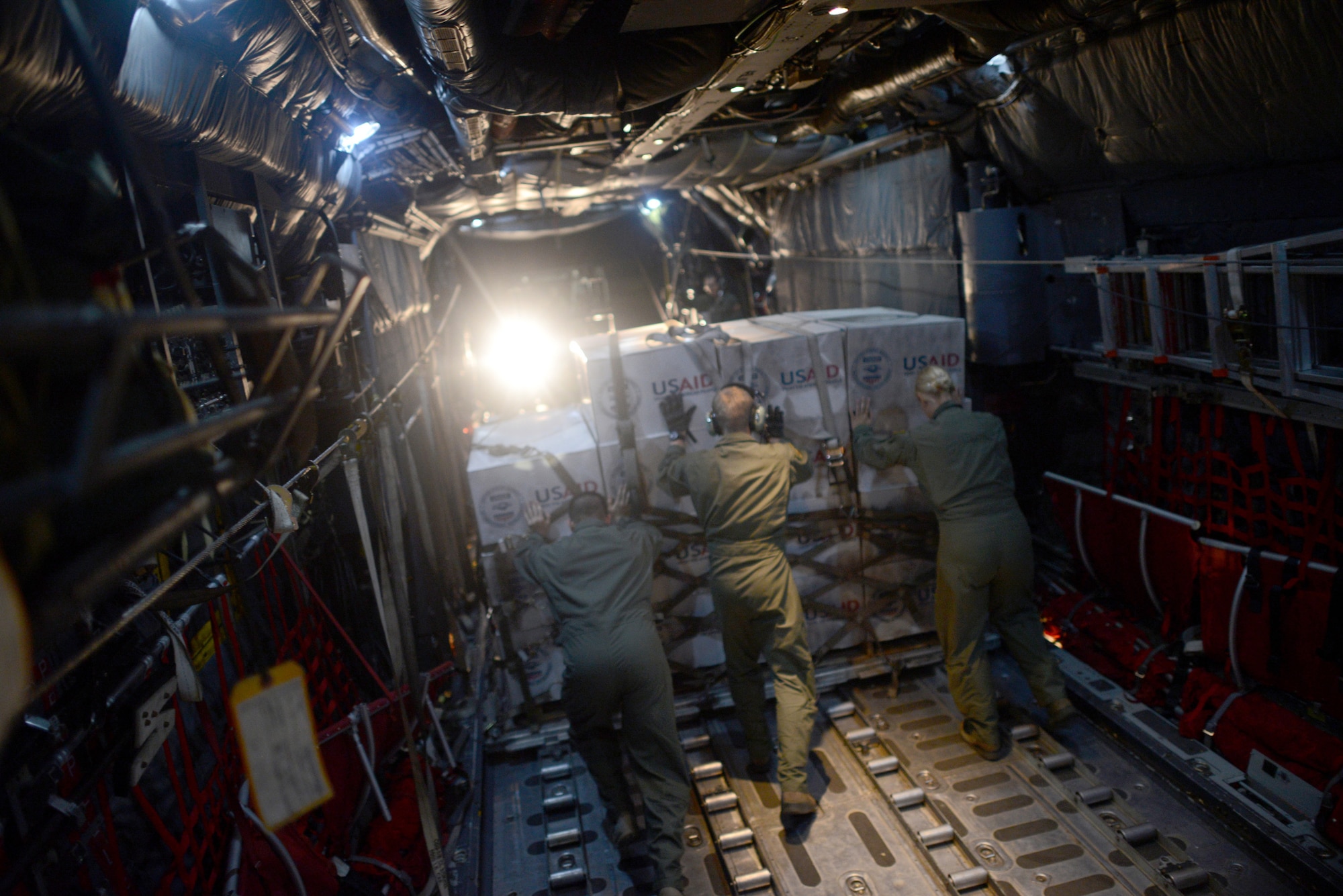 Airmen from the 36th Airlift Squadron, Yokota Air Base, Japan, offload humanitarian aid during Operation Damayan at Tacloban Airfield, Republic of the Philippines, Nov. 18, 2013. Operation Damayan is a humanitarian aid and disaster relief operation led by the Philippine government and supported by a multinational response force. (U.S. Air Force photo by 2nd Lt. Jake Bailey/Released)