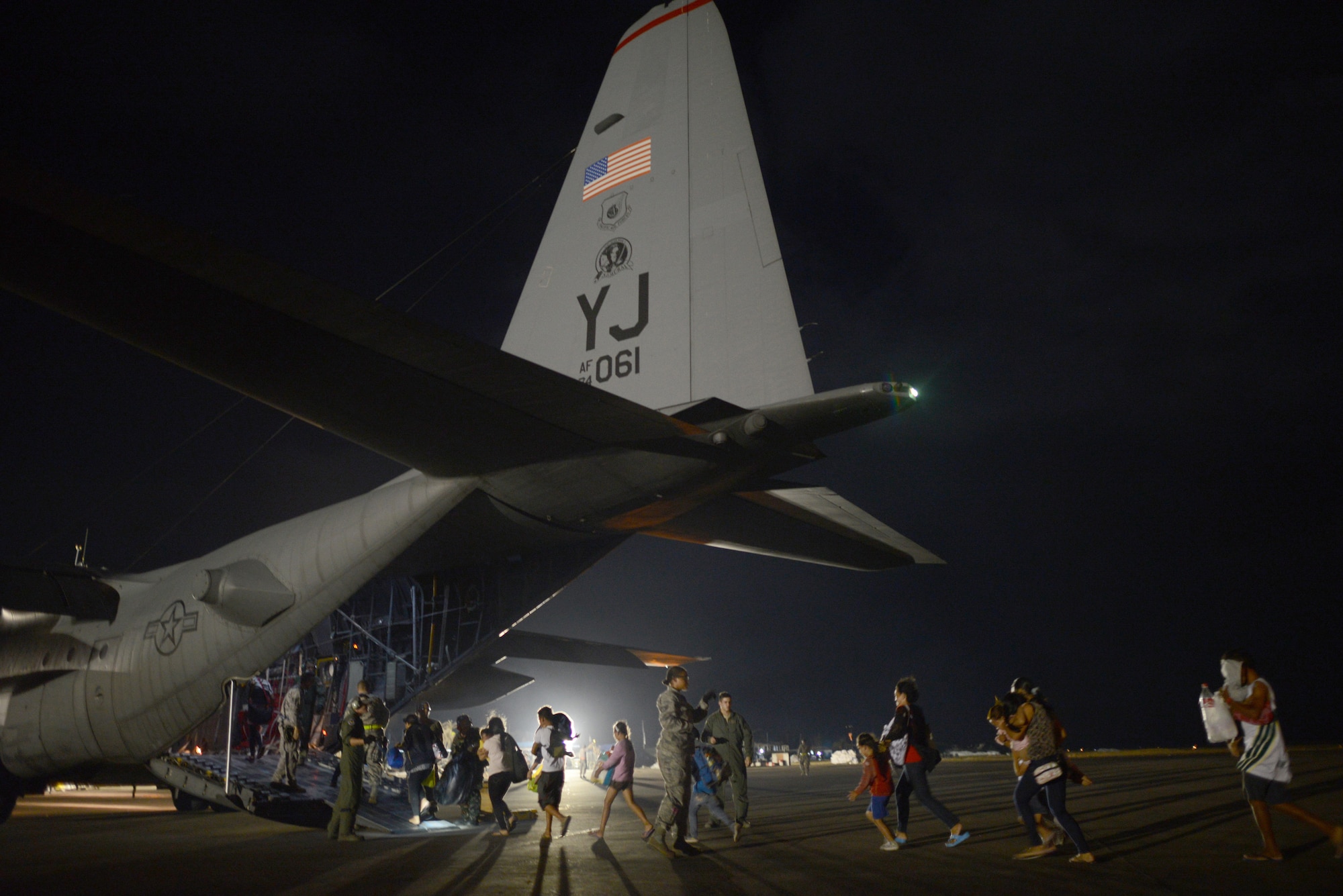 Evacuees board a U.S. Air Force C-130H at Tacloban Airport, Republic of the Philippines, during Operation Damayan Nov. 18, 2013. Operation Damayan is a humanitarian aid and disaster relief operation led by the Philippine government and supported by a multinational response force. (U.S. Air Force photo by 2nd Lt. Jake Bailey/Released)