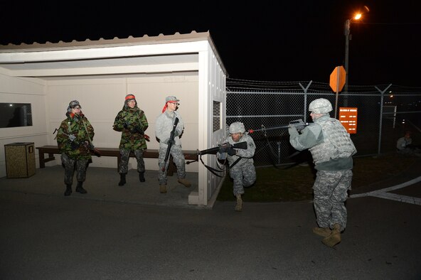 SUWON AIR BASE, Republic of Korea - Spc. Bekele Cherinet, an automated logistical specialist, and Sgt. Richard Firestine, a wheeled vehicle mechanic, both with Company F, 6th Battalion, 52nd Air Defense Artillery Regiment, confront U.S. and ROKAF troops acting as enemy special forces, trying to infiltrate Company F’s position during a base defense exercise here, Nov. 12.  (U.S. Army Photo by Sgt. Song, Sung Geun, Civil Affairs, 6-52nd ADA)