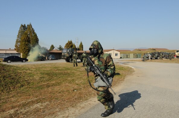 SUWON Air Base, Republic of Korea - Soldiers with Company F, 6th Battalion, 52nd Air Defense Artillery Regiment, wear chemical protective gear, responding to a simulated enemy missile launch, Nov. 12. (U.S. Army Photo by Sgt. Song, Sung Geun, Civil Affairs, 6-52 ADA)
