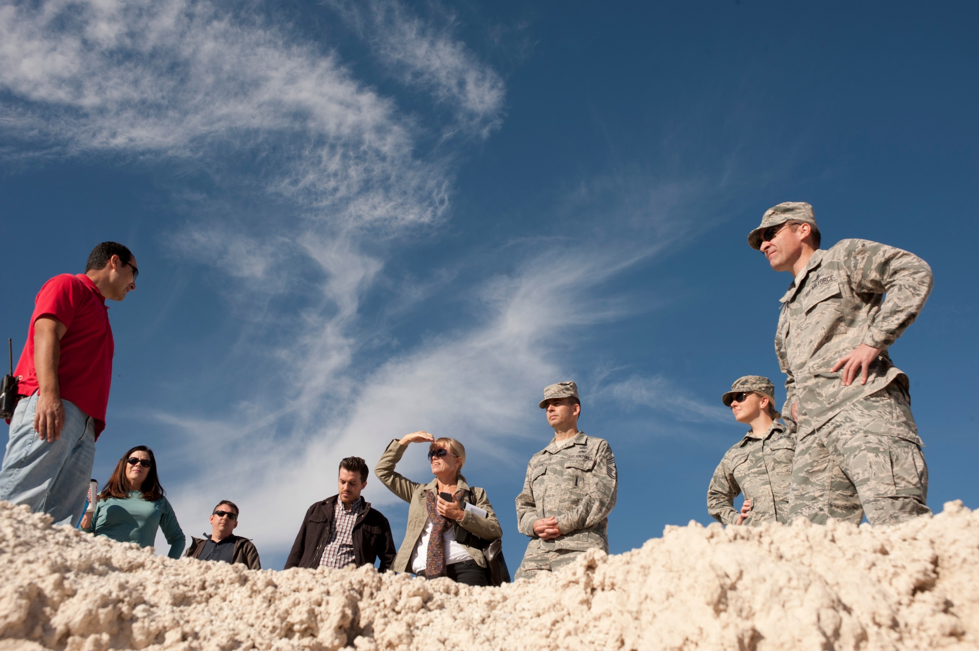 Col. Robert Ramsden, 99th Air Base Wing vice commander (right), and Chief Master. Sgt. Steven Cleveland, 99th ABW command chief (center), survey fossil beds excavated by archaeologists in the 1960s during a tour of Tule Springs, Las Vegas Nov. 18, 2013. The fossil beds are still visited periodically by University of Nevada Las Vegas paleontology students but are threatened by encroaching land development.  (U.S. Air Force photo by Airman 1st Class Joshua Kleinholz)