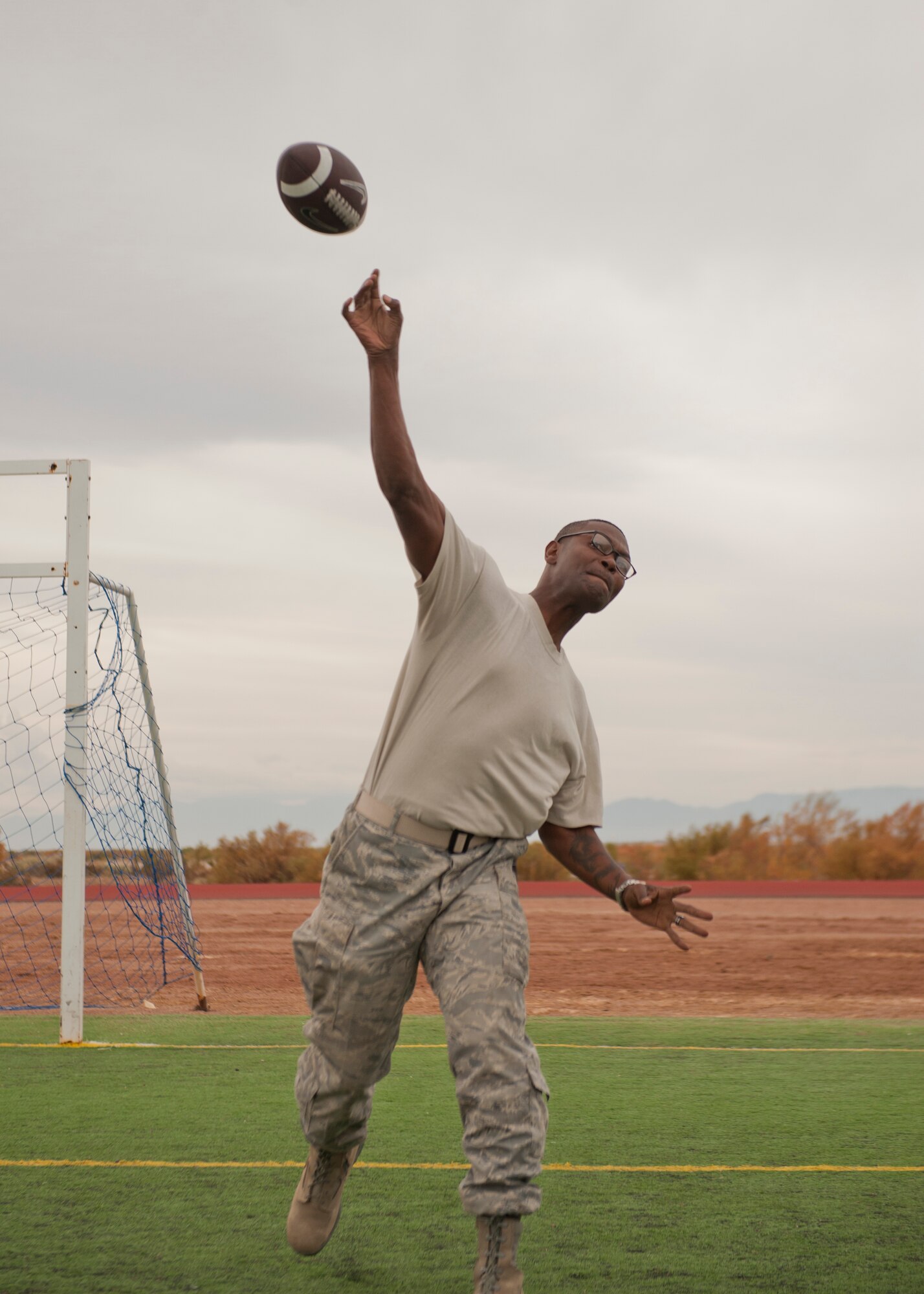 A member of Team Holloman competes in the football long throw contest as part of Sports Day at Holloman Air Force Base, N.M., Nov. 15. Sports Day is an annual event held through the Domenici Fitness and Sports Center, in which Holloman units to compete against one another in various team and individual events. (U.S. Air Force photo by Airman 1st Class Aaron Montoya/Released)