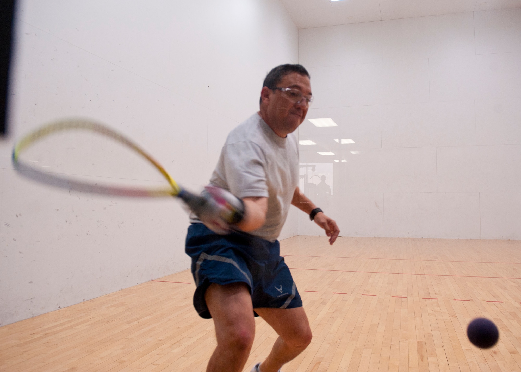 A member of Team Holloman returns a shot in a racquetball match as part of Sports Day at Holloman Air Force Base, N.M., Nov. 15. Sports Day is an annual event held through the Domenici Fitness and Sports Center, in which Holloman units to compete against one another in various team and individual events. (U.S. Air Force photo by Airman 1st Class Aaron Montoya/Released)