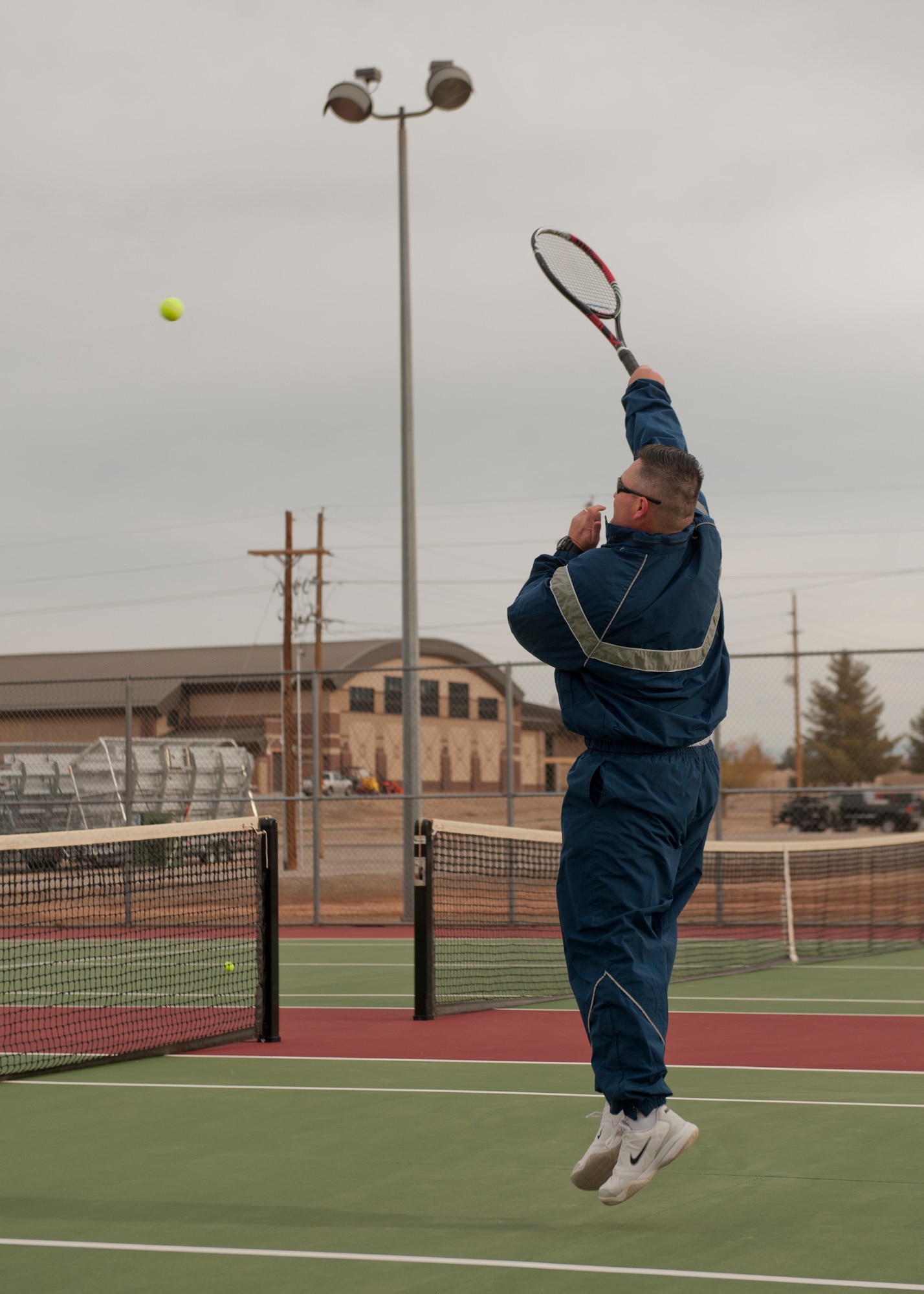 A member of Team Holloman returns a shot in a tennis match as part of Sports Day event at Holloman Air Force Base, N.M., Nov. 15. Sports Day is an annual event held through the Domenici Fitness and Sports Center, in which Holloman units to compete against one another in various team and individual events. (U.S. Air Force photo by Airman 1st Class Aaron Montoya/Released)