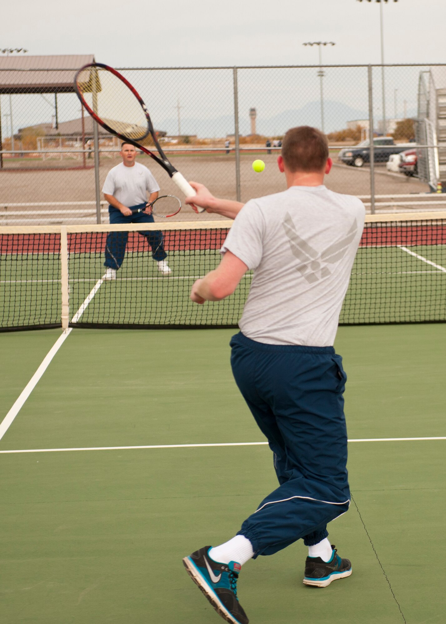 A member of Team Holloman returns a shot in a tennis match as part of Sports Day event at Holloman Air Force Base, N.M., Nov. 15. Sports Day is an annual event held through the Domenici Fitness and Sports Center, in which Holloman units to compete against one another in various team and individual events. (U.S. Air Force photo by Airman 1st Class Aaron Montoya/Released)