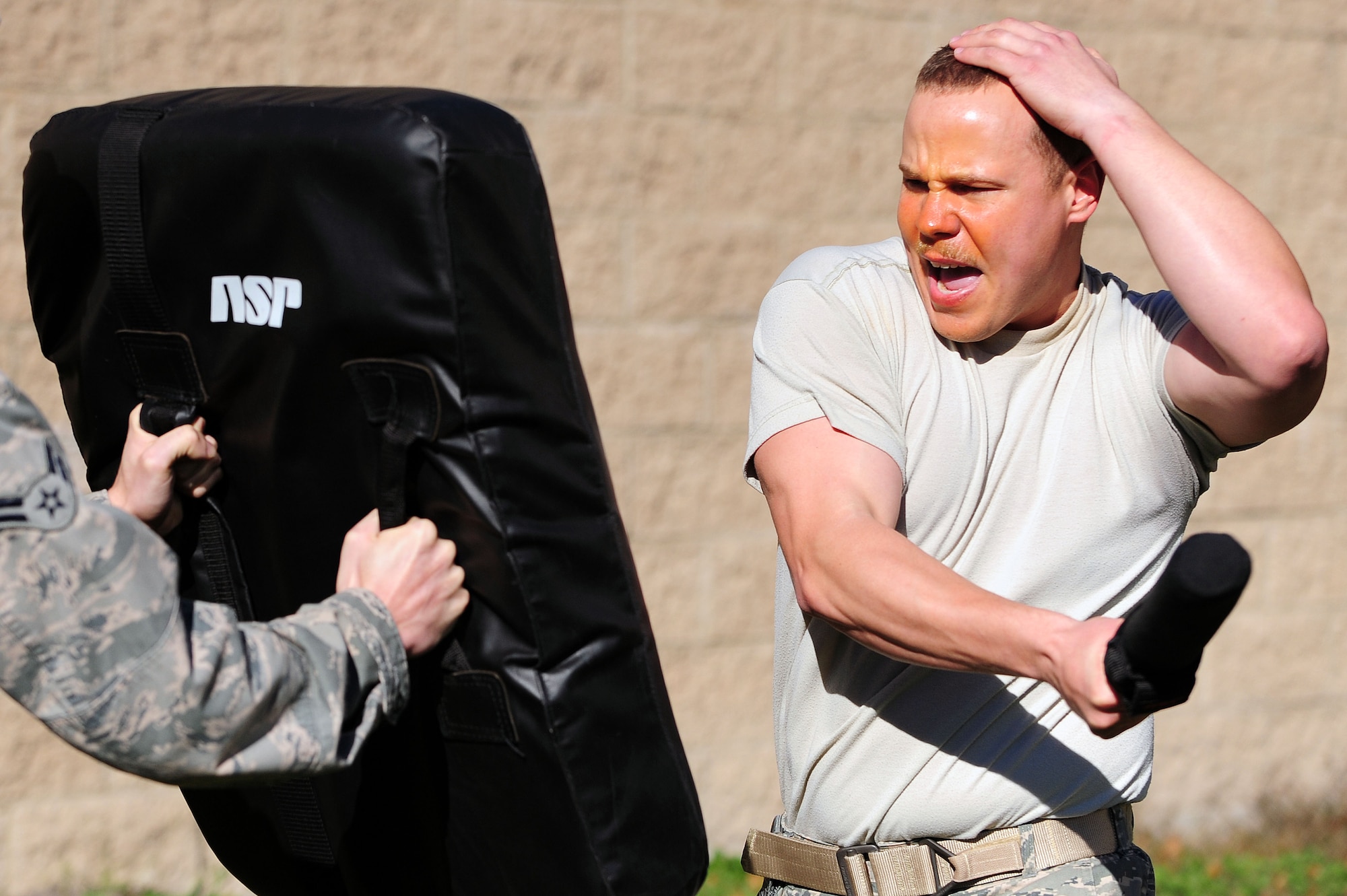 U.S. Air Force Airman 1st Class Aaron Jenne, 4th Fighter Wing public affairs photojournalist, defends himself during a simulated attack as part of a Security Forces Augmentee training class at Seymour Johnson Air Force Base, N.C., Nov. 8, 2013. After being subjected to oleoresin capsicum (OC) spray, Jenne had to fight through five obstacles to complete training. (U.S. Air Force photo by Airman 1st Class John Nieves Camacho)