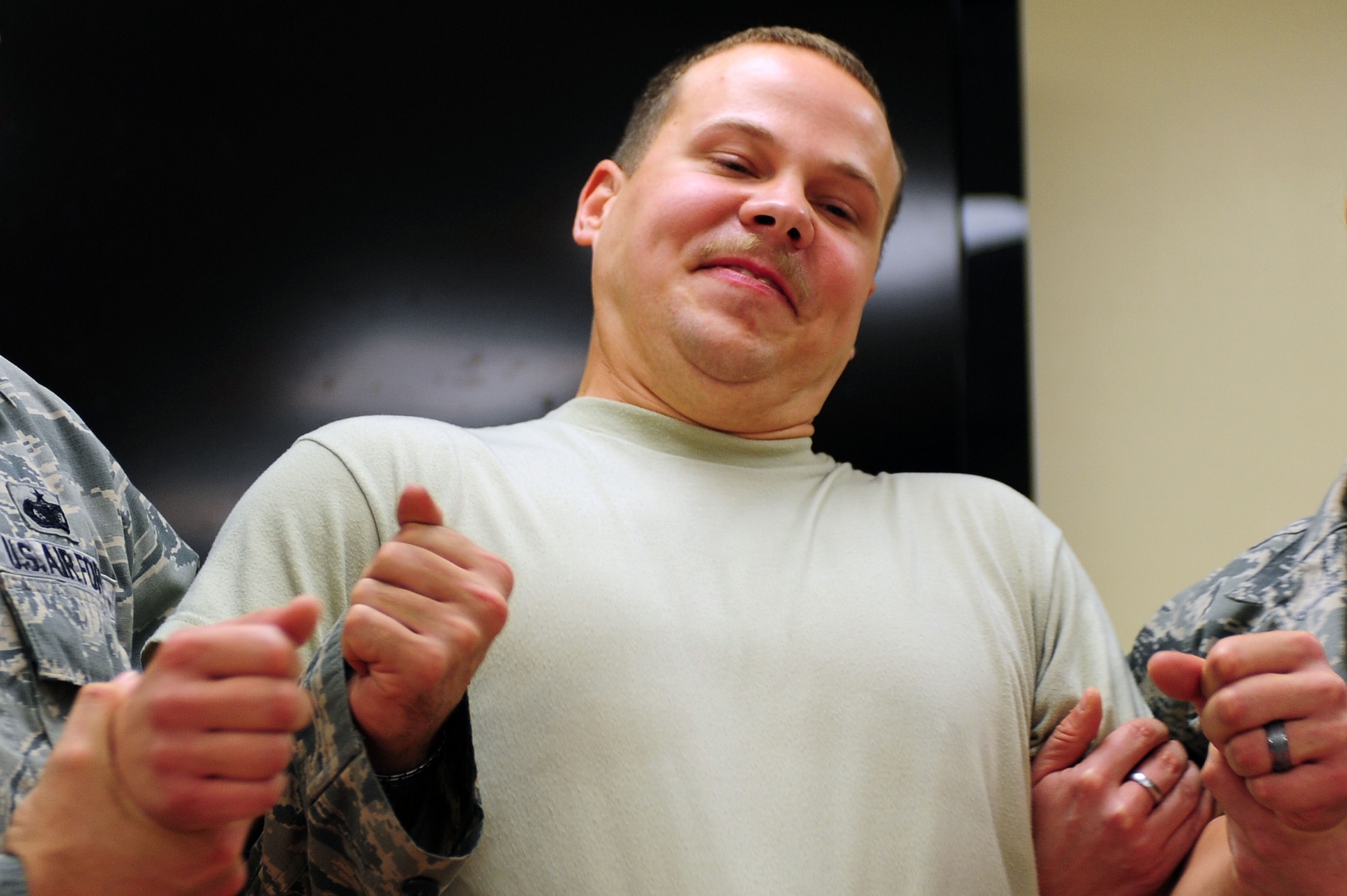 U.S. Air Force Airman 1st Class Aaron Jenne, 4th Fighter Wing public affairs photojournalist, feels the effects of a taser during a Security Forces Augmentee training class at Seymour Johnson Air Force Base, N.C., Nov. 8, 2013. The two day training course teaches Airmen law enforcement rules of engagement, safety procedures and weapon control. (U.S. Air Force photo by Airman 1st Class John Nieves Camacho)