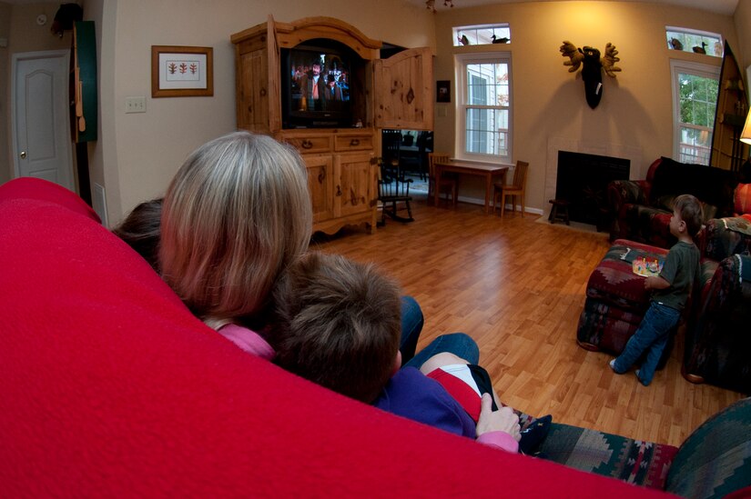 Master Sgt. Julie Dandaneau, 633rd Surgical Operations Squadron surgical services flight chief, watches a movie with her three children, Paige, Jack and Cooper, in their home in Newport News, Va., Nov. 16, 2013.  Dandaneau, unable to have children, adopted them from Russia. (U.S. Air Force photo by Stephanie R. Plichta/Released)