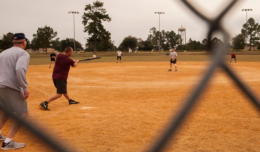 U.S. Air Force Chief Master Sgt. Thomas Moore, 23d Aircraft Maintenance Squadron superintendent, swings for a base hit at Moody Air Force Base, Ga., Nov. 15, 2013. Despite the effort from the Eagle’s defense, the Chiefs scored 15 runs in the first inning. (U.S. Air Force photo by Airman 1st Class Alexis Grotz/Released)
