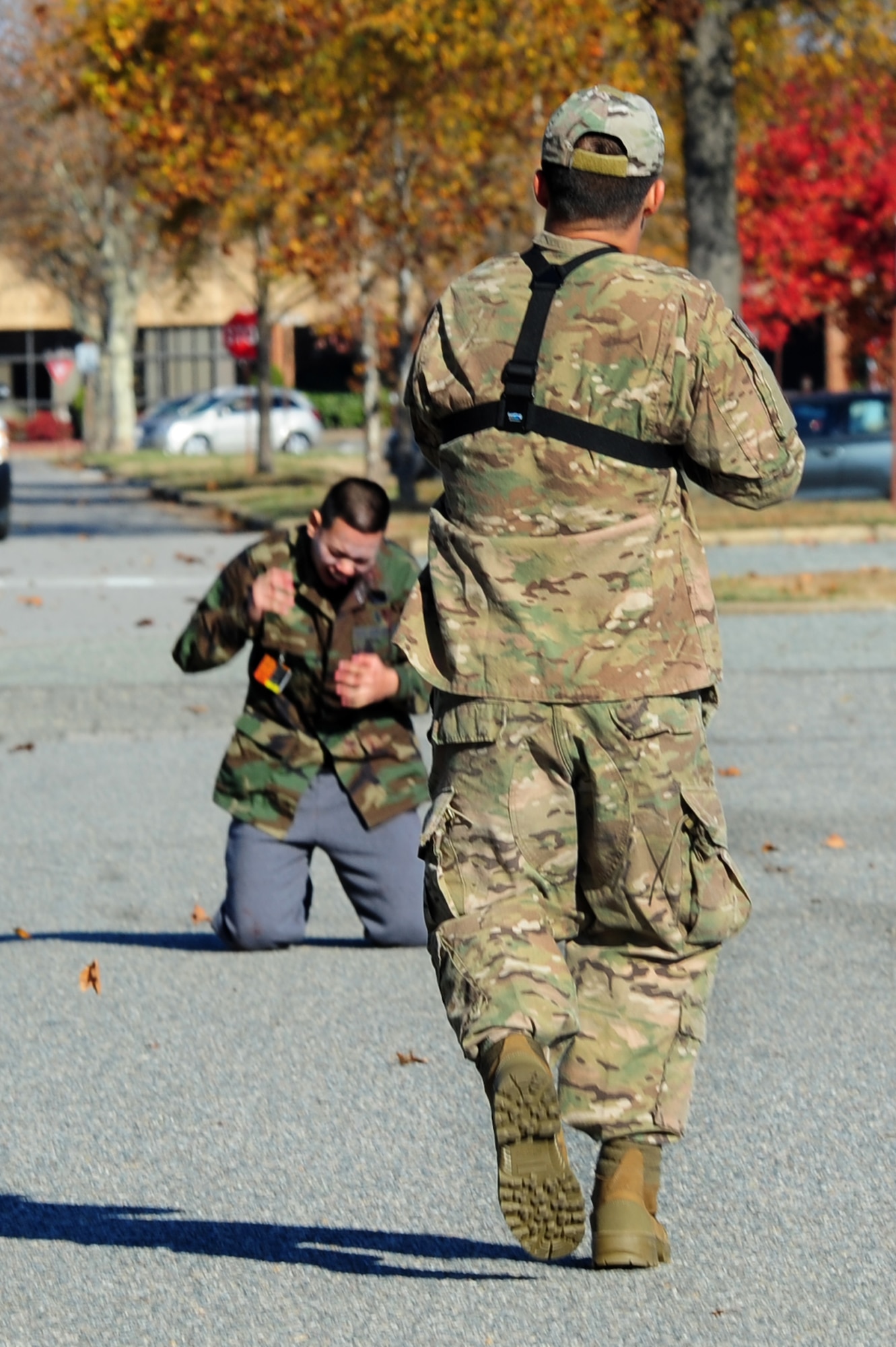 U.S. Air Force Master Sgt. Scott Wagonblott, 633rd Communications Squadron information assurance manager, simulates shooting Airman 1st Class Putthaporn Boonpreda, 633rd Civil Engineer Squadron air terminal representative, during an active-shooter exercise at Langley Air Force Base, Va., Nov. 19, 2013. The exercise tested the ability of personnel to handle possible threats during everyday operations. (U.S. Air Force photo by Airman Areca T. Wilson/Released)