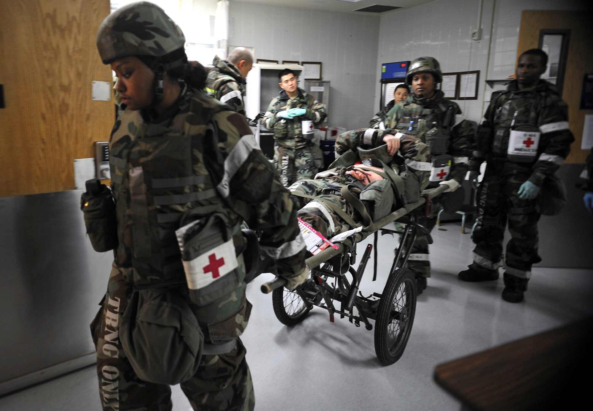 Members of the 51st Medical Group use a wheeled litter to move a simulated casualty during Operational Readiness Exercise Beverly Bulldog 14-01 at Osan Air Base, Republic of Korea, Nov. 20, 2013. Mass casualty situations in a real-world operation could require Airmen to call on their knowledge of not only care in a conventional setting, but also of care under fire. (U.S. Air Force photo/Staff Sgt. Sara Csurilla)