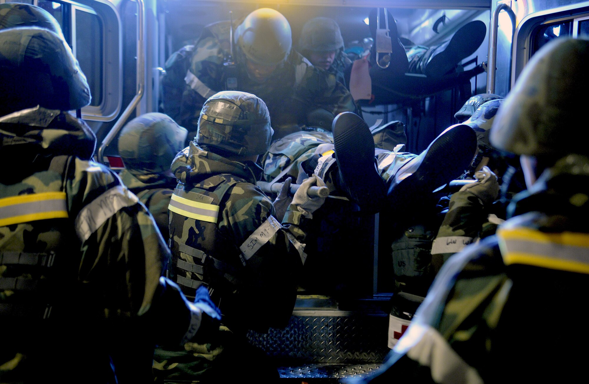 Members of the 51st Medical Group ease a simulated casualty out of an ambulance during Operational Readiness Exercise Beverly Bulldog 14-01 at Osan Air Base, Republic of Korea, Nov. 20, 2013. Although all Airmen are taught a measure of self aid and buddy care, medical personnel continue to be the focal point for preserving life, limb and eyesight. (U.S. Air Force photo/Staff Sgt. Sara Csurilla)