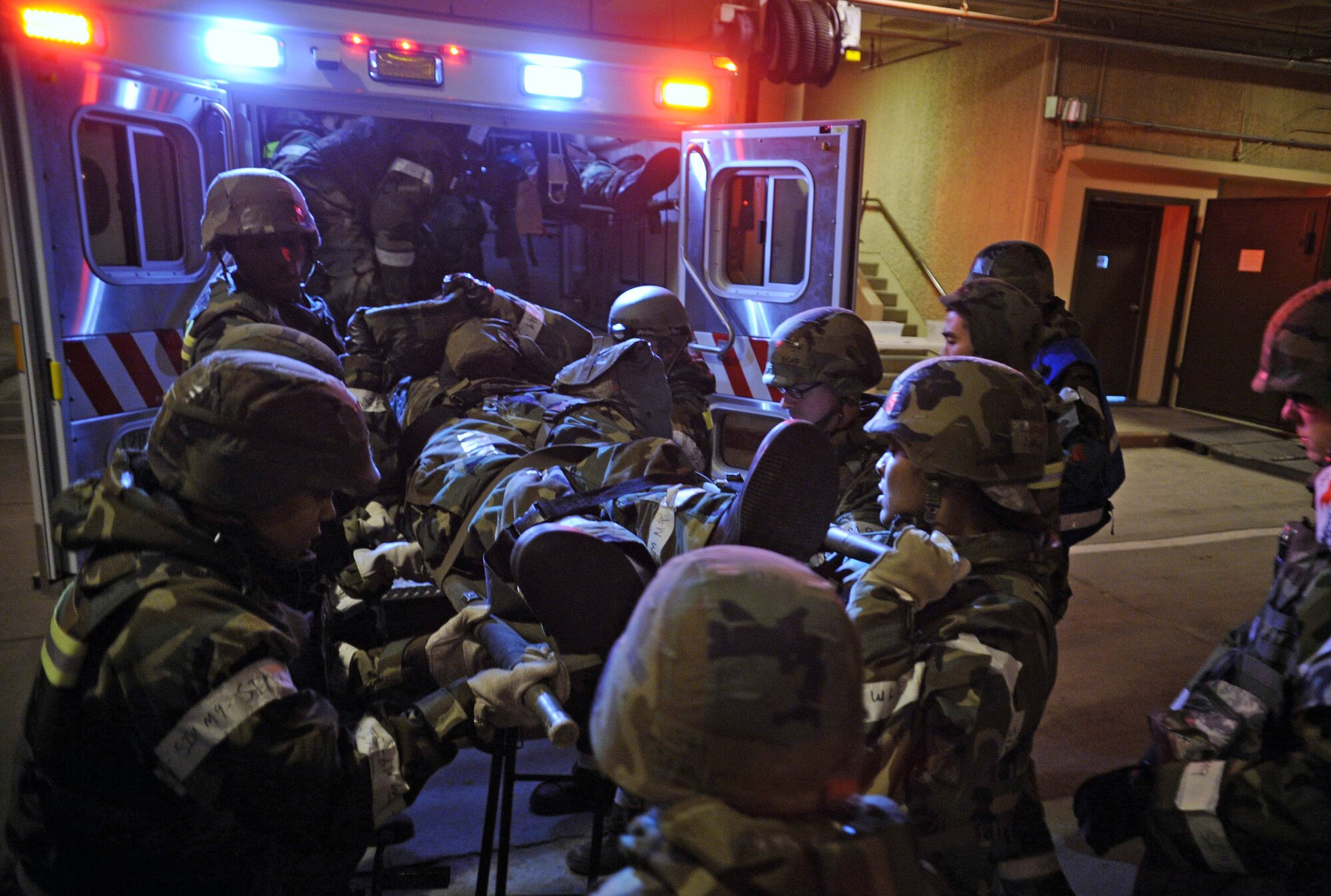Members of the 51st Medical Group ease a simulated casualty out of an ambulance during Operational Readiness Exercise Beverly Bulldog 14-01 at Osan Air Base, Republic of Korea, Nov. 20, 2013. Although all Airmen are taught a measure of self aid and buddy care, medical personnel continue to be the focal point for preserving life, limb and eyesight. (U.S. Air Force photo/Staff Sgt. Sara Csurilla)