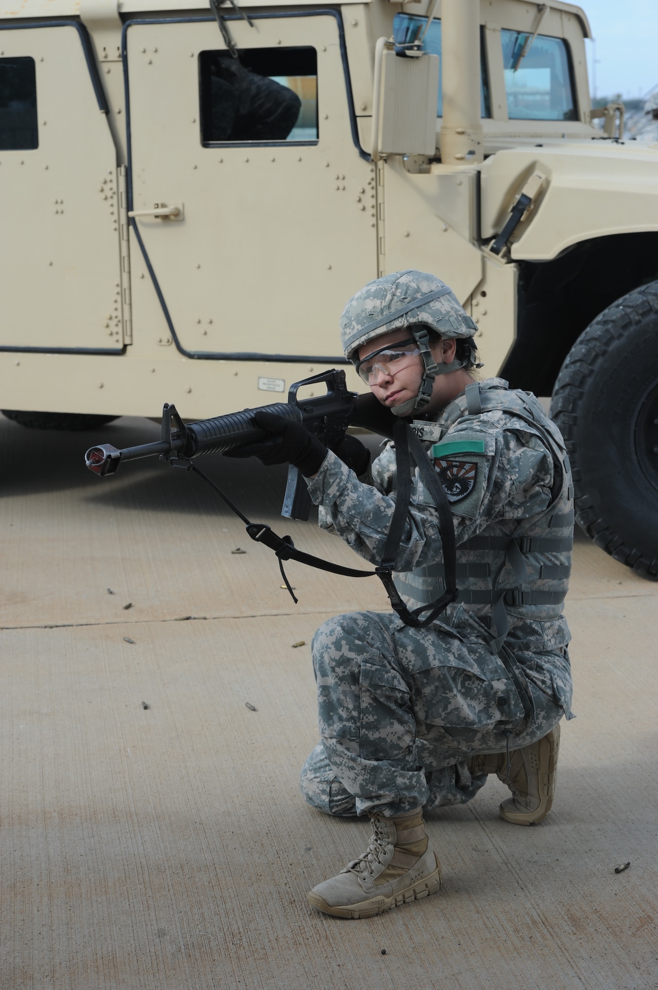 GOODFELLOW AIR FORCE BASE, Texas -- Army Pfc. Shelby Harris, 344th Military Intelligence Battalion student, takes a knee to pull security during the operations in urban terrain presentation of the 5th Annual Goodfellow Community Appreciation Day at the Louis F. Garland Department of Defense Fire Academy Nov. 16. The presentation gave members of the San Angelo and Goodfellow community an opportunity to see some of the training Soldiers receive while at Goodfellow. (U.S. Air Force photo/ Staff Sgt. Laura R. McFarlane)
