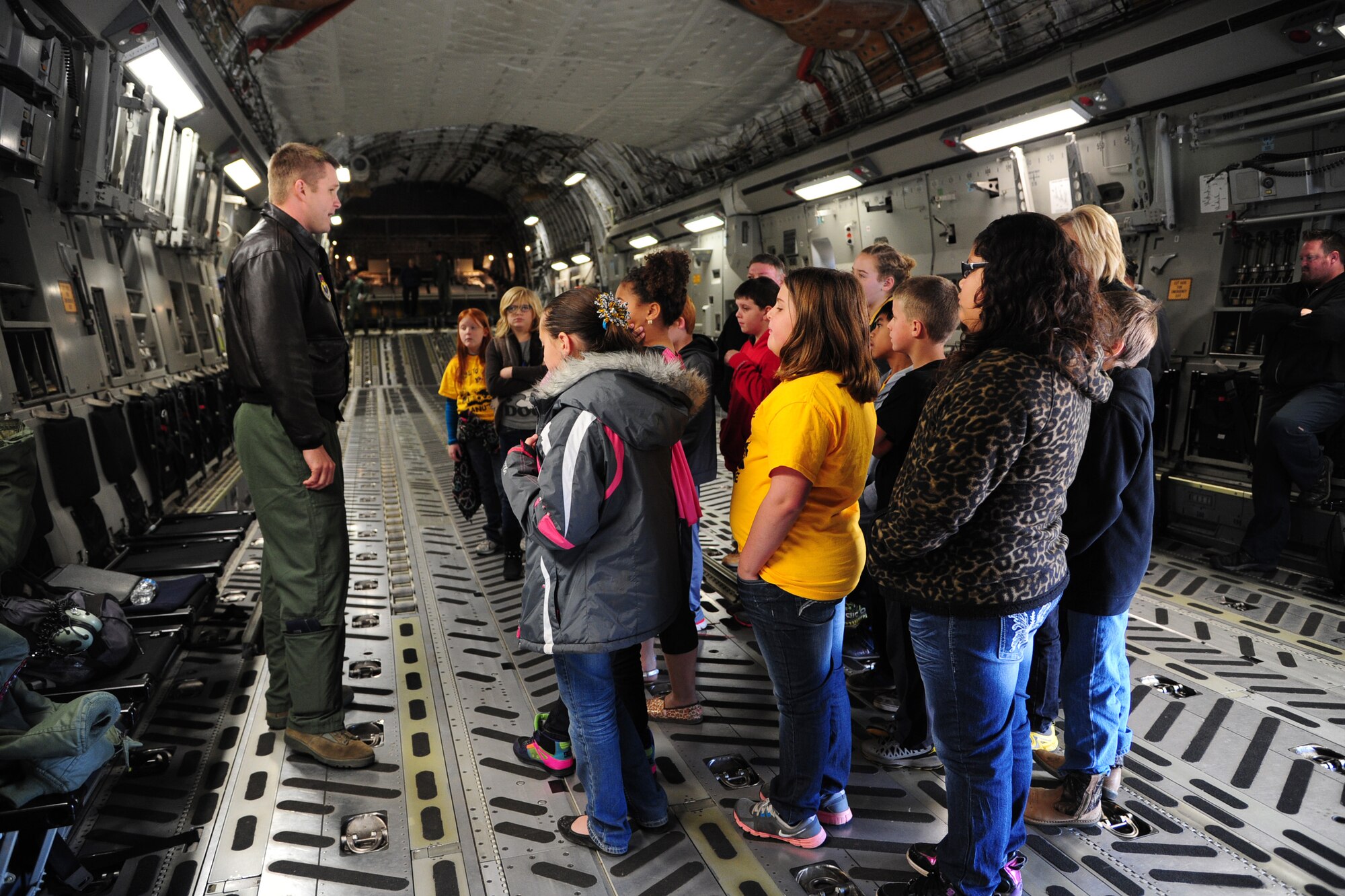 ALTUS AIR FORCE BASE, Okla. -- U.S. Air Force Capt. Clark Grosvenor, 97th Operations Support Squadron instructor pilot, gives fifth-grade students a tour of a U.S. Air Force C-17 Globemaster III cargo aircraft during the Burns Flat STARBASE Career Day Nov. 18, 2013. The students also toured a KC-135 Stratotanker refueler and various base agencies to learn how science, technology, engineering and math are applied to jobs in the military. The STARBASE program aims to motivate students to explore STEM as they continue their education. (U.S. Air Force photo by Senior Airman Lausanne Genuino/Released)