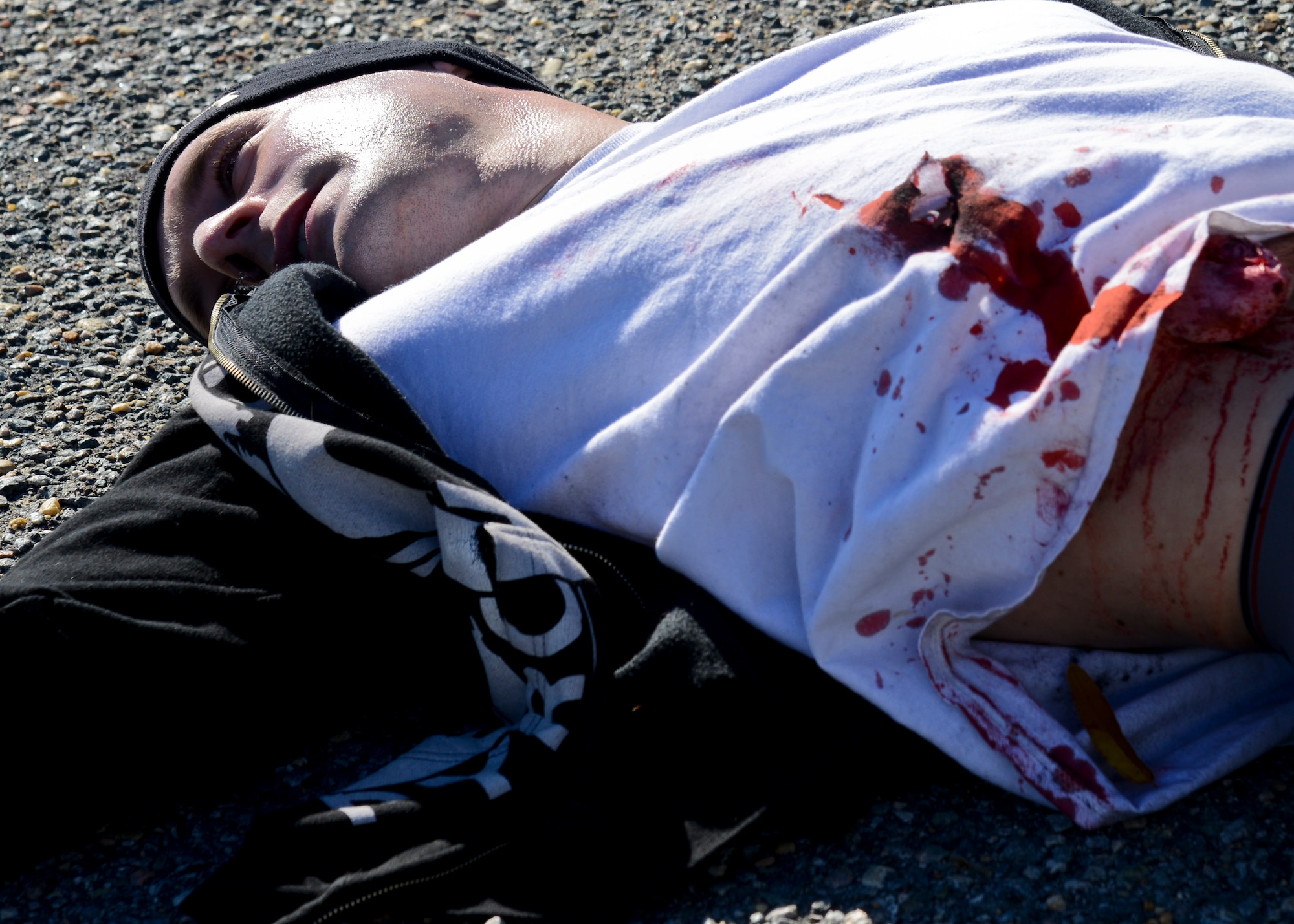 U.S. Air Force 1st Lt. Jonathon Rhodes, 633rd Communications Squadron wing information assurance officer in charge, awaits medical attention during an active-shooter exercise at Langley Air Force Base, Va., Nov. 19, 2013. During the simulation, victims were transported from the scene by the 633rd Civil Engineer Squadron fire protection team.(U.S. Air Force photo by Airman 1st Class Victoria H. Taylor/Released)